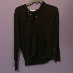 Black hoded sweater with a pocket with small hole on top